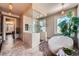 Spa-like bathroom featuring a glass-enclosed shower and a soaking tub with an outside view at 680 N Emerson St, Denver, CO 80218