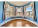 Charming bay window bathes the room with natural light, highlighting the hardwood floors at 680 N Emerson St, Denver, CO 80218