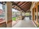 Spacious covered porch with brick pillars and views of the landscaped front yard at 680 N Emerson St, Denver, CO 80218