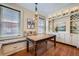 Cozy dining area with built-in banquette seating, stylish lighting, and custom cabinetry at 680 N Emerson St, Denver, CO 80218