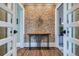 Inviting foyer featuring hardwood floors, a unique accent wall, and a decorative console table at 680 N Emerson St, Denver, CO 80218