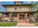Inviting front entrance with wooden doors, landscaped garden and brick facade at 680 N Emerson St, Denver, CO 80218