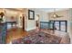 Hallway with hardwood floors features a decorative rug and views of the staircase at 680 N Emerson St, Denver, CO 80218