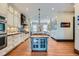 Spacious kitchen featuring custom cabinets, a center island, and hardwood flooring at 680 N Emerson St, Denver, CO 80218