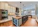 Open concept kitchen with granite countertops, stainless steel appliances, and a functional center island at 680 N Emerson St, Denver, CO 80218
