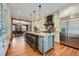 Chef's kitchen with high-end appliances, center island seating, and hardwood floors at 680 N Emerson St, Denver, CO 80218