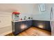 Charming kitchenette nook with dark blue cabinetry, granite counter tops, and a skylight at 680 N Emerson St, Denver, CO 80218