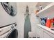 Convenient laundry room features modern washer and dryer, utility sink, and ample storage space at 680 N Emerson St, Denver, CO 80218
