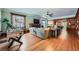 Open living room featuring hardwood floors, a fireplace, and built-in bookshelves at 680 N Emerson St, Denver, CO 80218