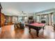 Bright living room with a pool table, a fireplace, and a large window at 680 N Emerson St, Denver, CO 80218