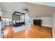 Bright main bedroom featuring a four-poster bed, ceiling fan, and hardwood floors at 680 N Emerson St, Denver, CO 80218