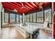 Bright sunroom with red wood ceilings, expansive windows, and a creative workspace at 680 N Emerson St, Denver, CO 80218