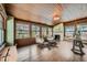 Bright sunroom with floor to ceiling windows, a wood ceiling, and a cozy seating area at 680 N Emerson St, Denver, CO 80218