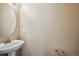 Simple bathroom with pedestal sink and large mirror at 9543 Pearl Cir # 101, Parker, CO 80134