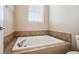 Clean bathroom with soaking tub and tile surround at 9543 Pearl Cir # 101, Parker, CO 80134