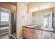 Double vanity bathroom with large mirror and shower at 9543 Pearl Cir # 101, Parker, CO 80134