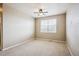 Spacious bedroom with ceiling fan and neutral carpeting at 9543 Pearl Cir # 101, Parker, CO 80134