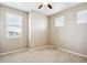 Well-lit bedroom with neutral carpeting and two windows at 9543 Pearl Cir # 101, Parker, CO 80134