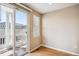 Bright bedroom with wood floors and access to a private balcony at 9543 Pearl Cir # 101, Parker, CO 80134