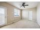 Bright bedroom with ceiling fan and access to balcony at 9543 Pearl Cir # 101, Parker, CO 80134