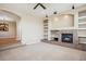 Living room featuring a fireplace and built-in shelving at 9543 Pearl Cir # 101, Parker, CO 80134