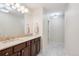 Bathroom with double vanity, marble countertops, and recessed lighting above tiled floor at 1512 Larimer St # 39, Denver, CO 80202