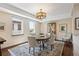 Dining area featuring wood floors, patterned rug, and modern light fixture at 1512 Larimer St # 39, Denver, CO 80202