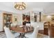 Dining area open to the kitchen, featuring hardwood floors and a modern chandelier at 1512 Larimer St # 39, Denver, CO 80202