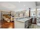 Open-concept kitchen features granite counters, modern appliances, and flows into the living area with fireplace at 1512 Larimer St # 39, Denver, CO 80202