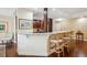 Well-appointed kitchen with granite counters, breakfast bar, and dark wood cabinetry exudes warmth and sophistication at 1512 Larimer St # 39, Denver, CO 80202