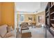 Bright living room featuring an inviting sitting area, a desk, and a large built-in bookcase at 1512 Larimer St # 39, Denver, CO 80202