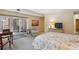 Spacious bedroom featuring balcony access, side table, and television set atop a wooden drawer at 1512 Larimer St # 39, Denver, CO 80202