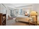 Bright bedroom with balcony access, two sitting chairs, and a comfortable queen bed at 1512 Larimer St # 39, Denver, CO 80202