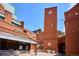 Writer Square's clock tower and brick buildings create a charming urban scene with shops and outdoor seating at 1512 Larimer St # 39, Denver, CO 80202