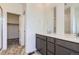 Bathroom featuring double sinks, quartz countertops, and tile flooring with a walk in shower at 2018 S Haleyville Way, Aurora, CO 80018