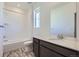 Bathroom featuring single sink, quartz countertops, and tile flooring with a shower and tub at 2018 S Haleyville Way, Aurora, CO 80018