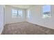 Bedroom featuring neutral carpeting, white walls, base molding, and large bright windows at 2018 S Haleyville Way, Aurora, CO 80018
