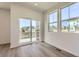 Bright living room with light hardwood floors, white walls, and large windows for plenty of natural light at 2018 S Haleyville Way, Aurora, CO 80018