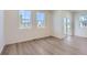 Bright living room with light hardwood floors, white walls, and large windows for plenty of natural light at 2018 S Haleyville Way, Aurora, CO 80018