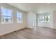 Bright living room with light hardwood floors, white walls, and large windows for plenty of natural light at 2018 S Haleyville Way, Aurora, CO 80018