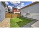 Backyard featuring a small patch of artificial turf, gravel, and wood fence at 3390 Cranston Cir, Highlands Ranch, CO 80126