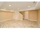 Basement with natural wood flooring, built-in shelving, and stairs at 3390 Cranston Cir, Highlands Ranch, CO 80126