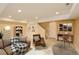 Staged basement with wooden floors, built in shelves and recreational area at 3390 Cranston Cir, Highlands Ranch, CO 80126
