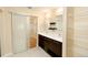 This bathroom features dual sinks, a vanity with drawers, a large mirror and tile floors at 3390 Cranston Cir, Highlands Ranch, CO 80126