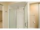 This bathroom features a glass shower door, white tile and a shower head at 3390 Cranston Cir, Highlands Ranch, CO 80126