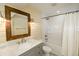 Bathroom features a white subway tile shower, framed mirror, gray vanity, and ship lap accent wall at 3390 Cranston Cir, Highlands Ranch, CO 80126