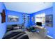 Blue themed staged bedroom with a mounted skateboard display and workspace at 3390 Cranston Cir, Highlands Ranch, CO 80126