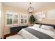 This bedroom features neutral walls, hardwood floors, plantation shutters and a decorative light fixture at 3390 Cranston Cir, Highlands Ranch, CO 80126