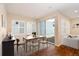 Bright dining room area with hardwood floors, modern lighting, and sliding door access to yard at 3390 Cranston Cir, Highlands Ranch, CO 80126