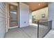 Covered front porch with modern door, stone accents, and a sleek railing at 3390 Cranston Cir, Highlands Ranch, CO 80126